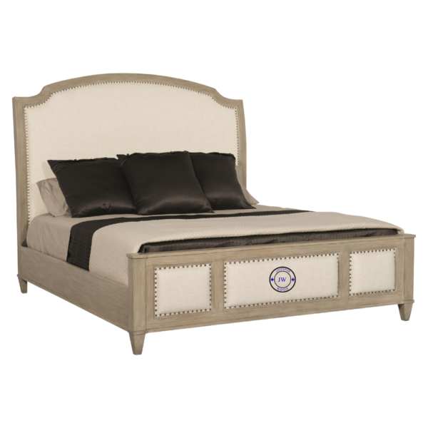 Close-up of the Banjara Hill Panel Bed’s upholstered headboard with nailhead trim and oak wood frame in Earth finish.