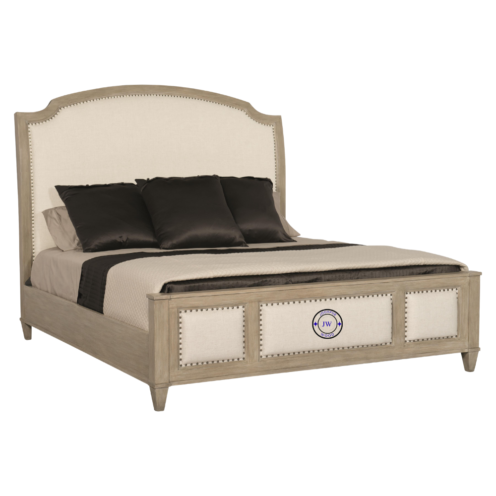 Close-up of the Banjara Hill Panel Bed’s upholstered headboard with nailhead trim and oak wood frame in Earth finish.