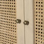 Close up of natural cane weave on wooden sideboard doors