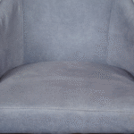 Close-up of upholstered fabric dining chair with soft texture and stitching detail