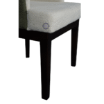 Close-up of ivory Bouclé fabric and wooden legs of luxury accent chair showing texture and solid wood structure